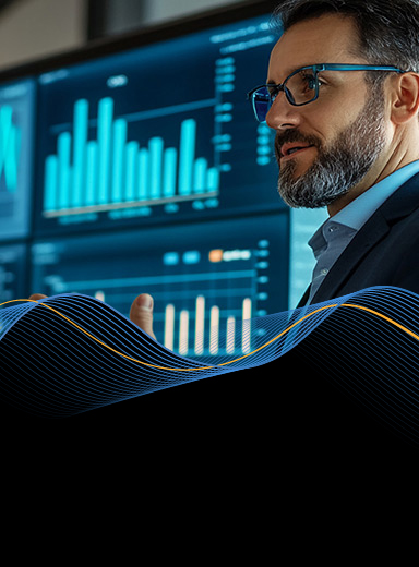 Man in formal attire near screen with bar charts